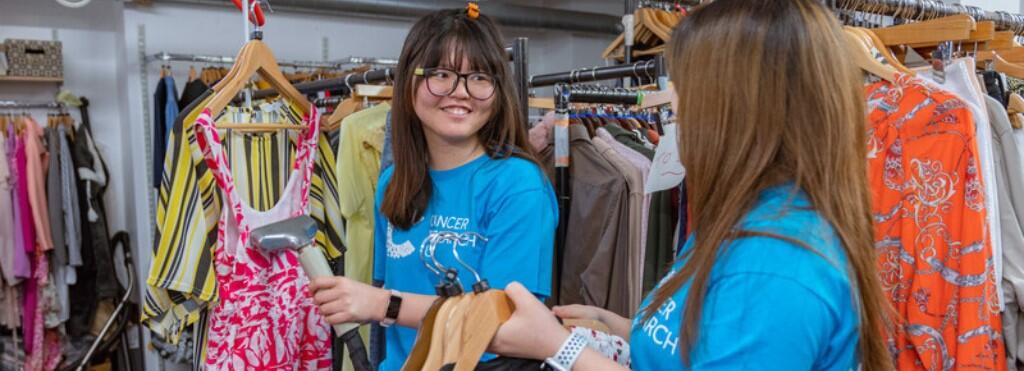 Two volunteers working in the shop