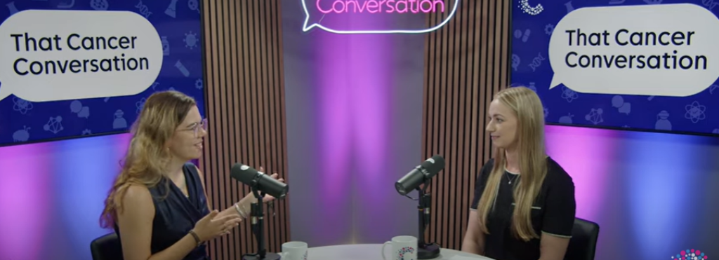 Two women sitting and speaking to each other