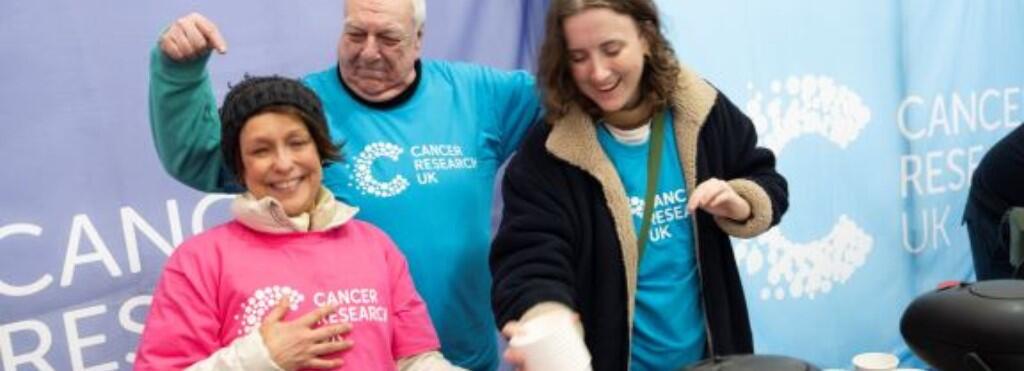 Three volunteers smiling 