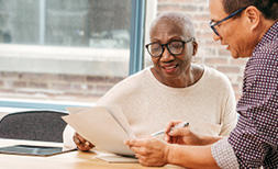 Two people going through documentation