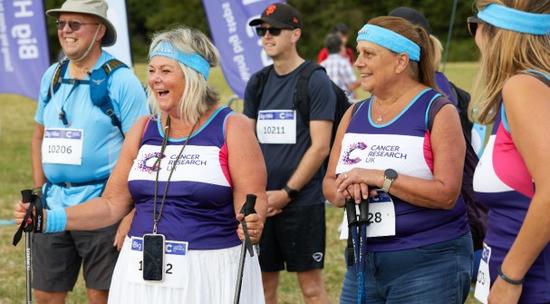 Three Big Hike participants with CRUK t-shirts, at the start line of the hike. They're smiling and laughing