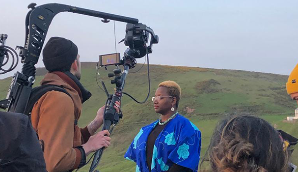 bami on cliff with film crew