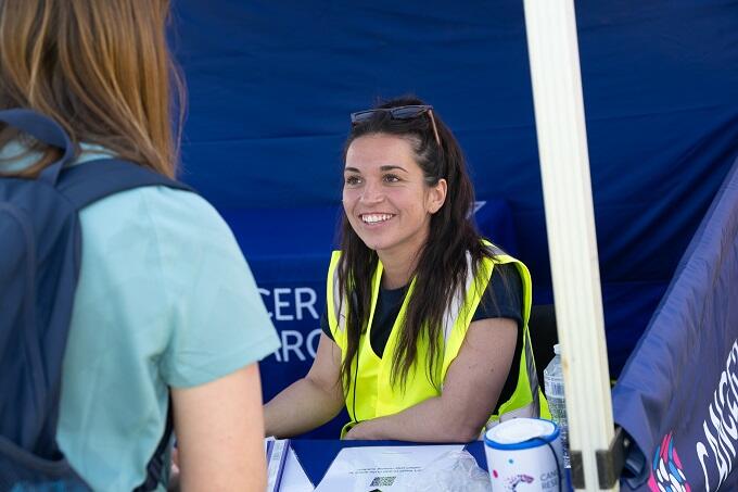 Volunteer smiling in the registration tent
