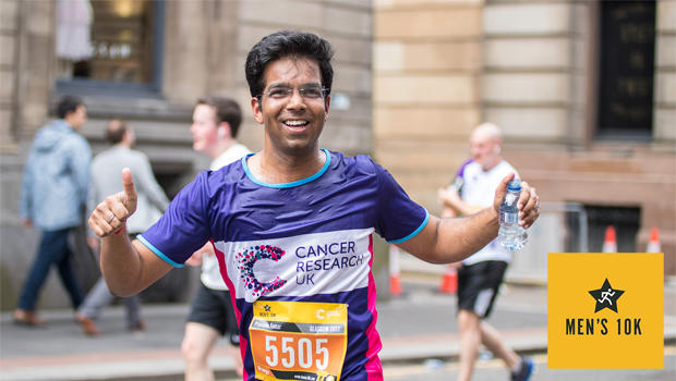 Man smiling whilst running the 10k Glasgow