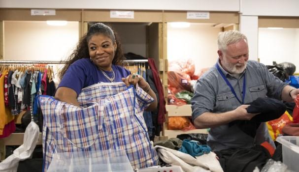Shop volunteers looking at stock in a shop
