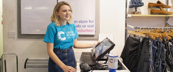 Young female volunteer behind the till