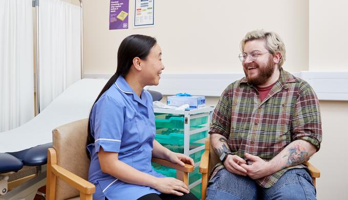Nurse speaking to a transgender male patient about cervical screening