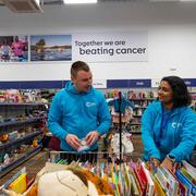 Two shop volunteers working together and smiling 