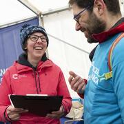 Volunteers smiling in the registration tent