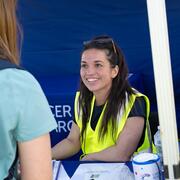Volunteer smiling in the registration tent