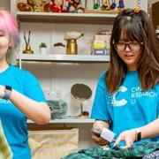 Two female shop volunteers sorting through clothes