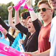 Volunteers cheering alongside a race 