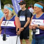 Three Big Hike participants with CRUK t-shirts, at the start line of the hike. They're smiling and laughing